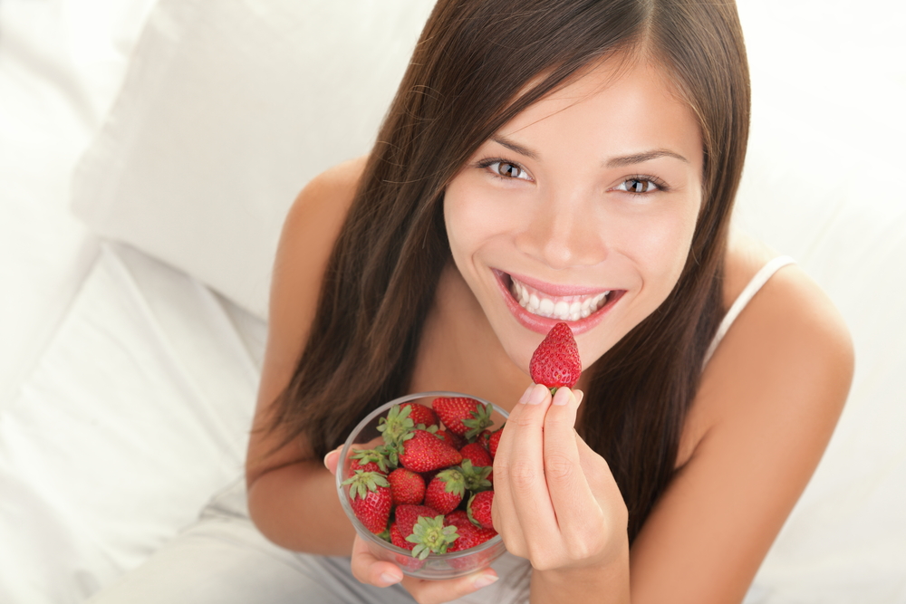 woman eating strawberry